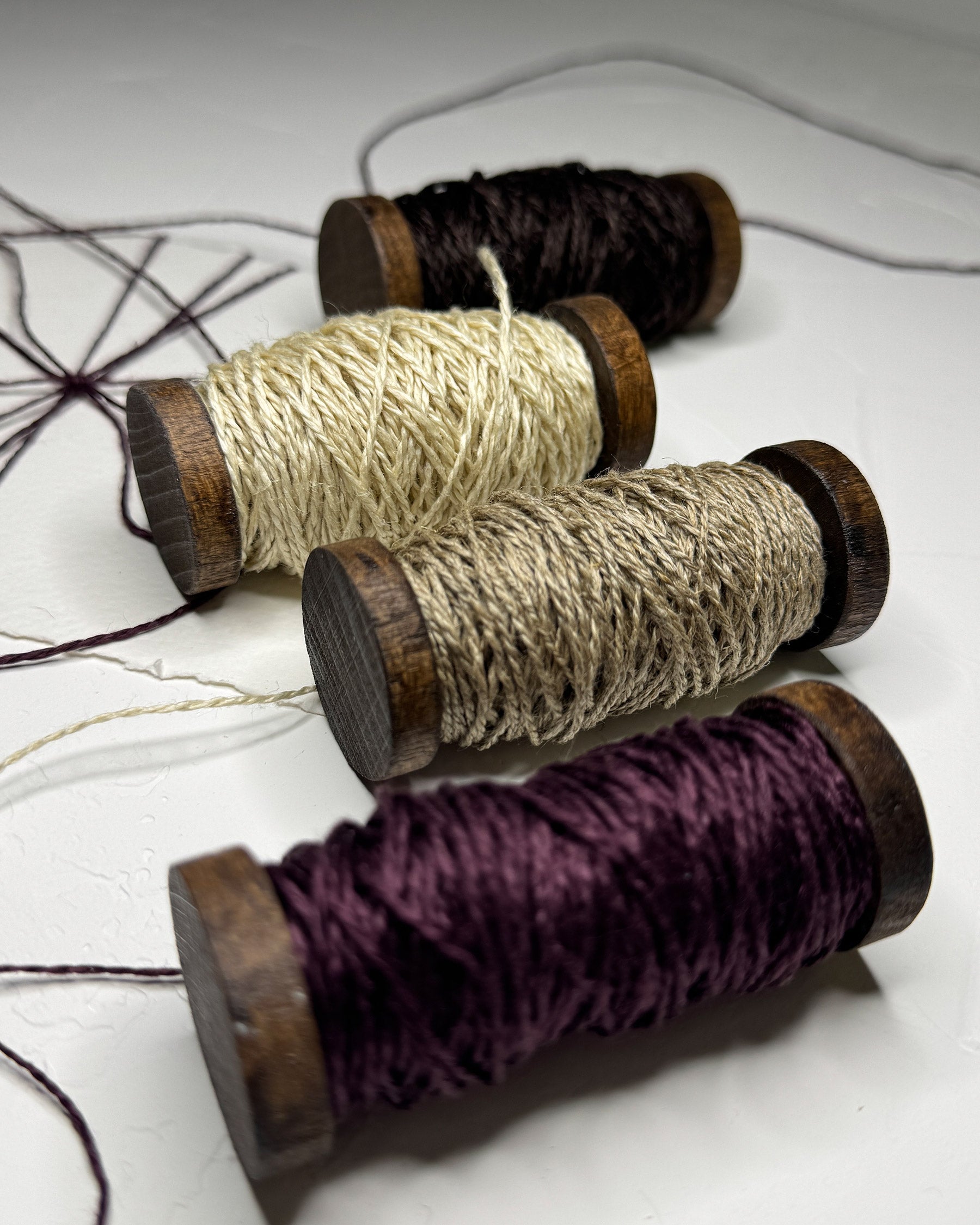 Linen twine on wooden spools for wedding stationery