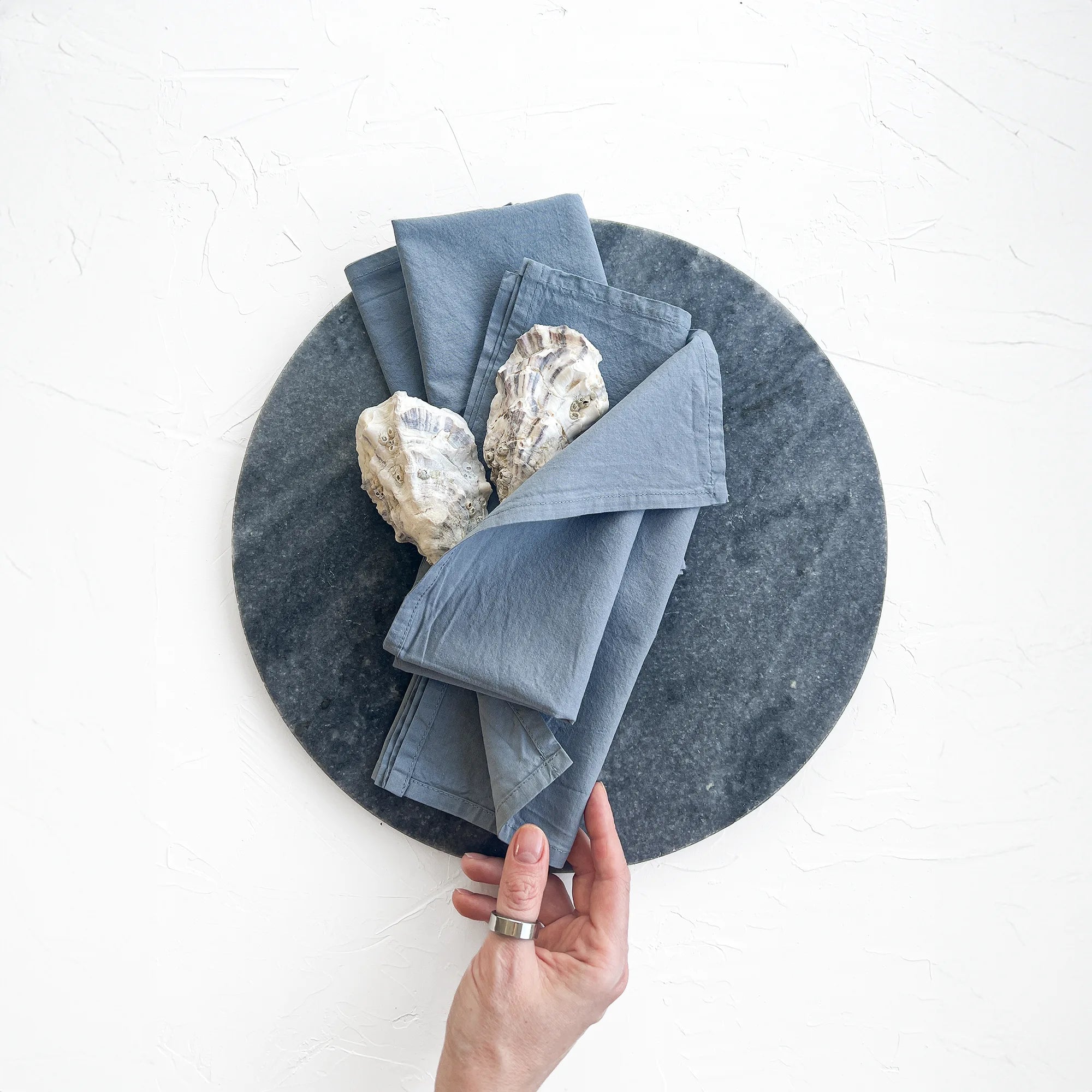 Dusty blue washed cotton hand dyed napkins on table