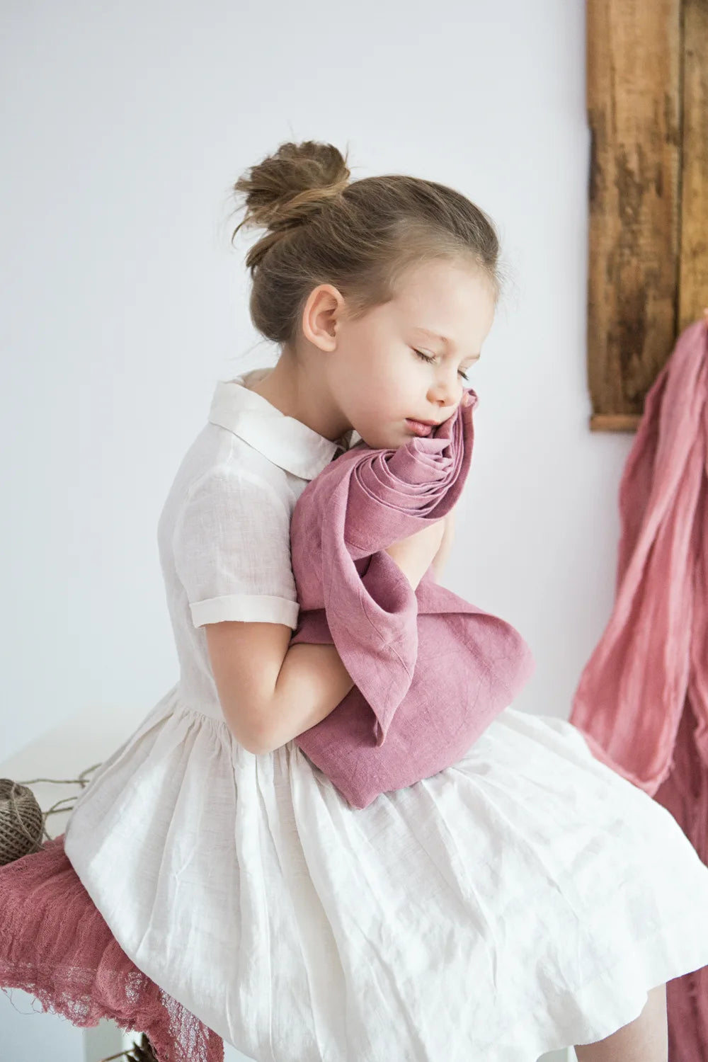 Linen lark hand dyed linens cloth in hands of little girl in white dress